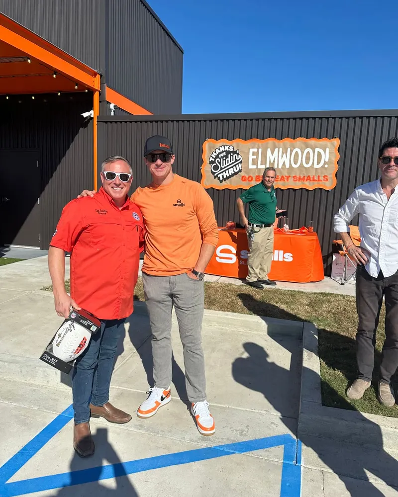 Mayor Tim Baudier supporting a local business opening in Elmwood