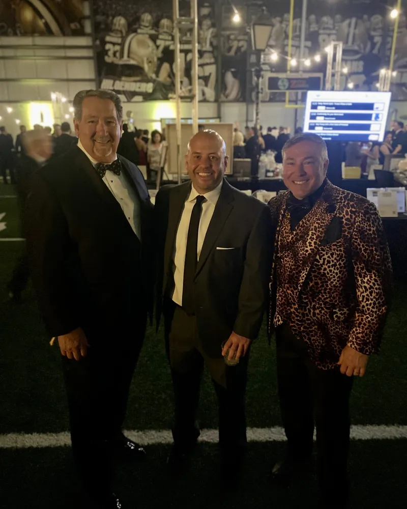 Tim Baudier with friends at a formal Saints-themed gala