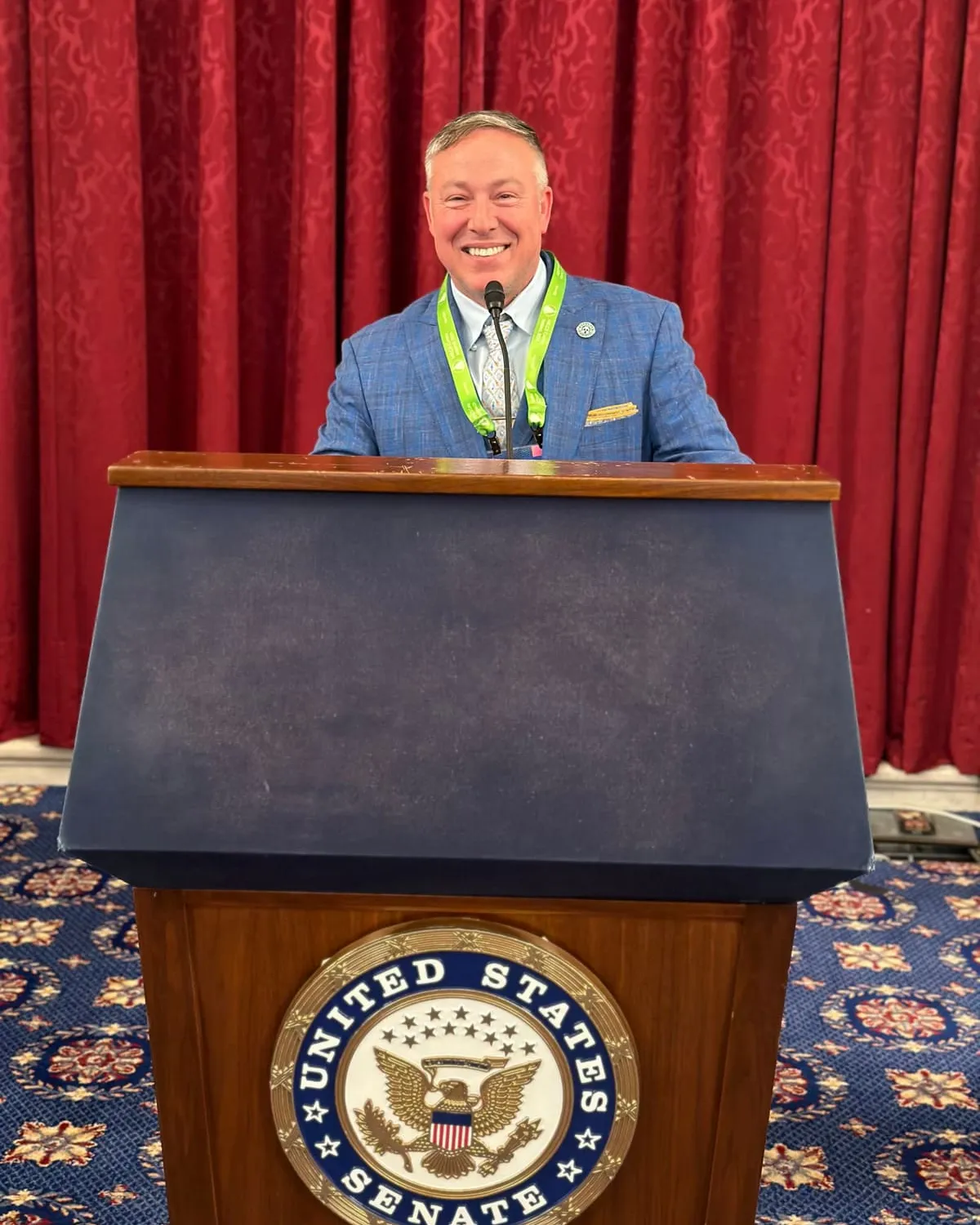 Tim Baudier speaking at a United States Senate podium